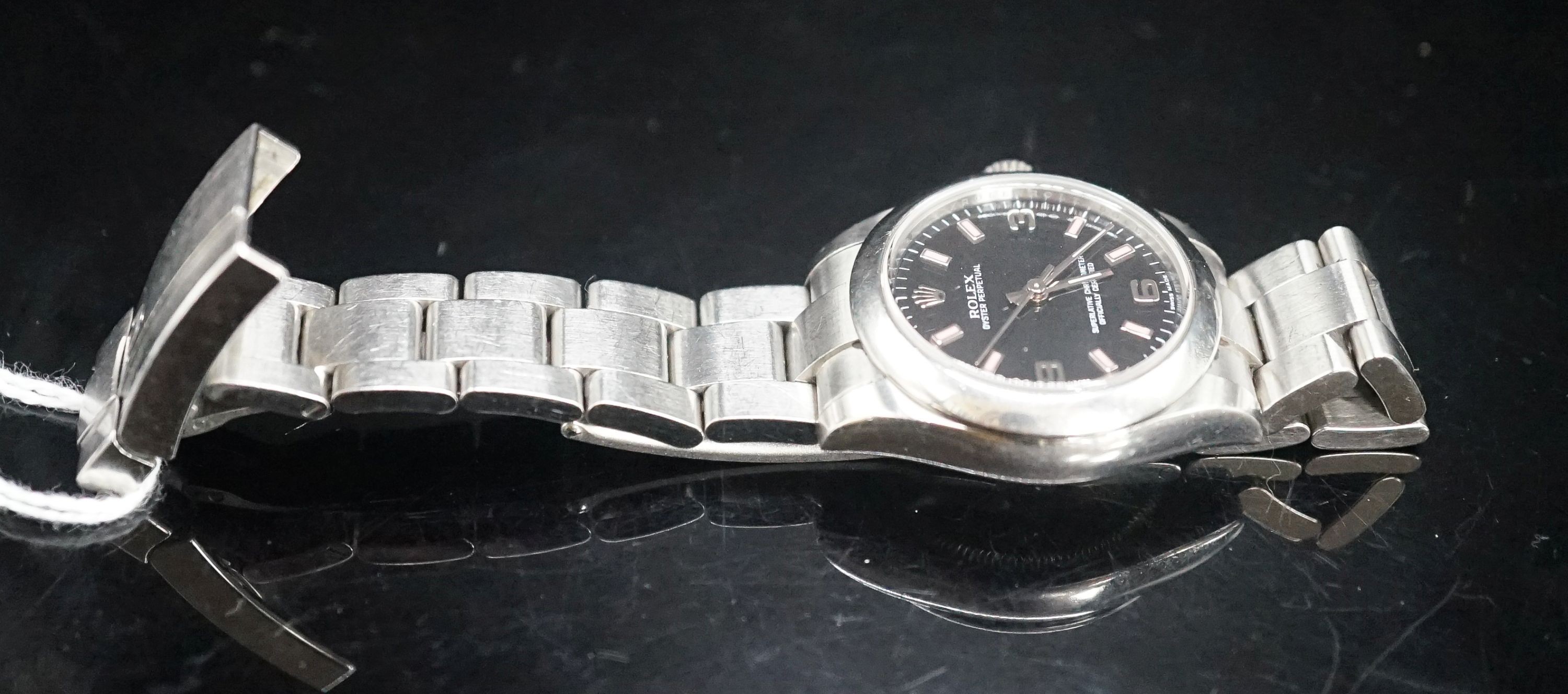 A lady's modern stainless steel Rolex Oyster Perpetual wrist watch, on a stainless steel Rolex bracelet, case diameter 31mm, no box or papers.